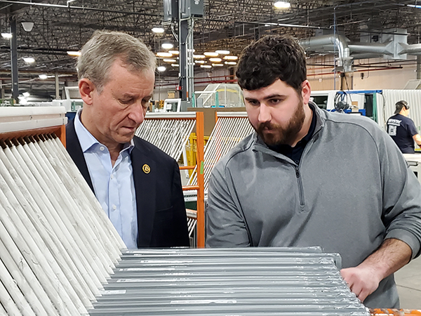 Cartwright (left) and Plant Manager Mike DelPrete inspect insulated glass units