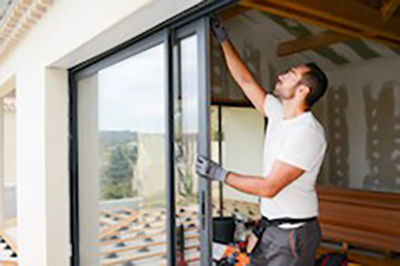 Installer works on sliding door