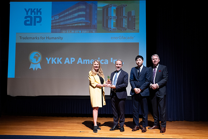 YKK AP is presented its award at a ceremony